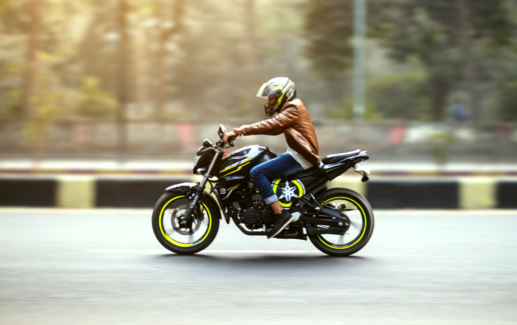 Rider on a motorcycle with yellow powder coated wheels