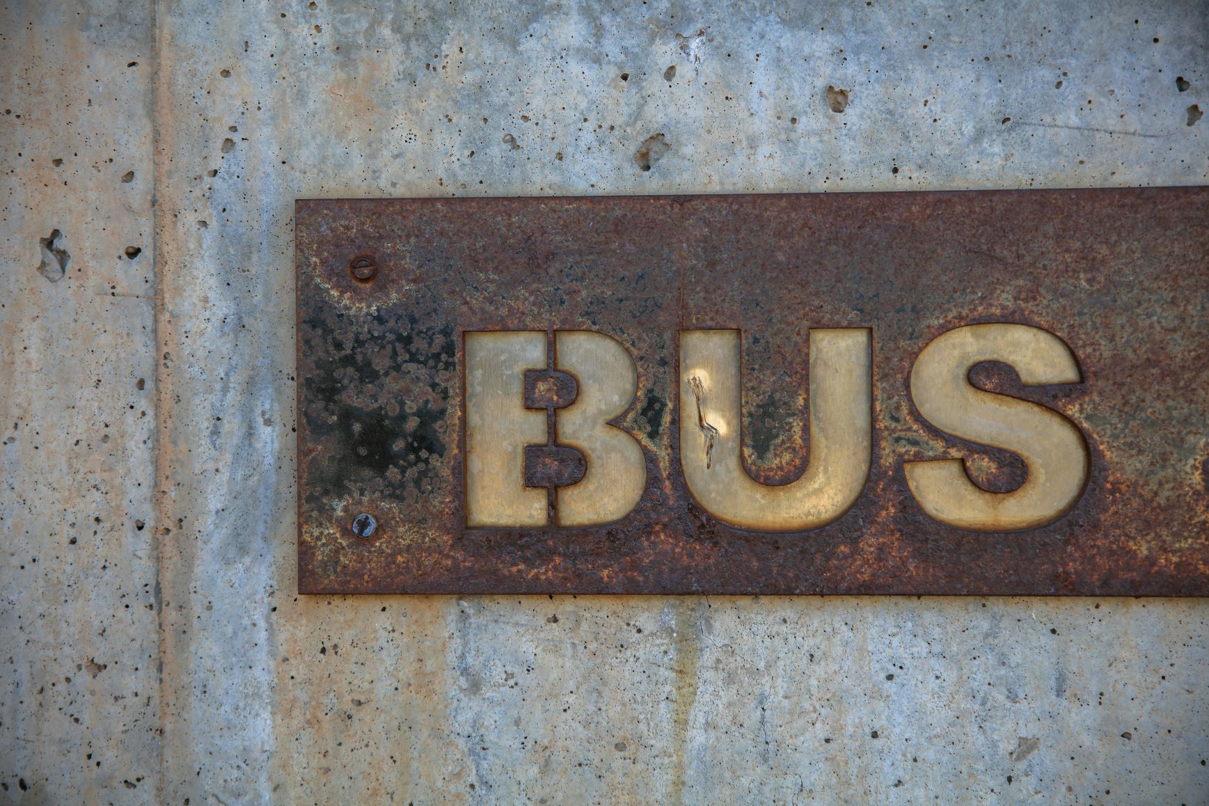 Rusty metal bus sign before restoration