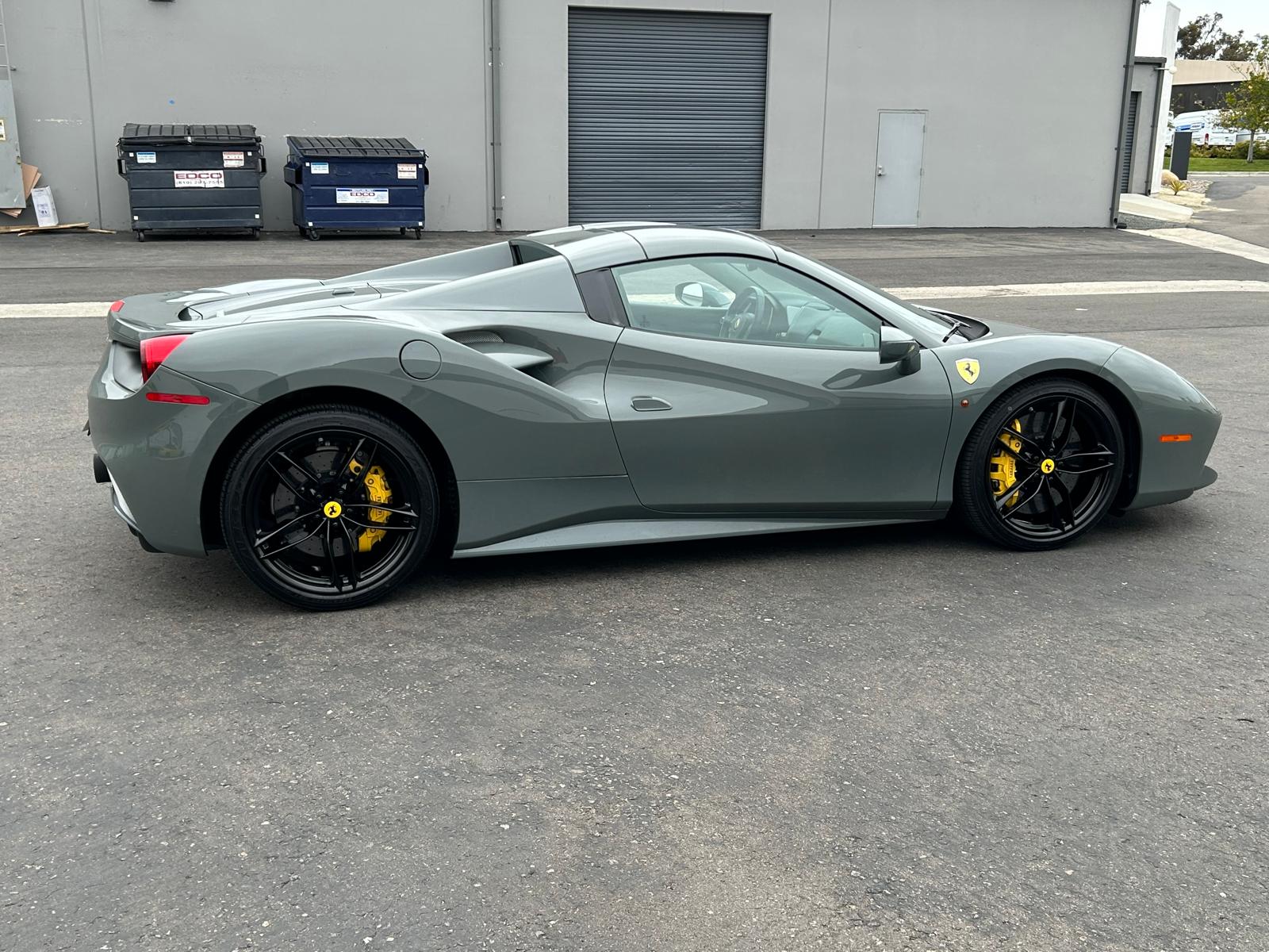 Ferrari with powder coated black wheels and yellow calipers