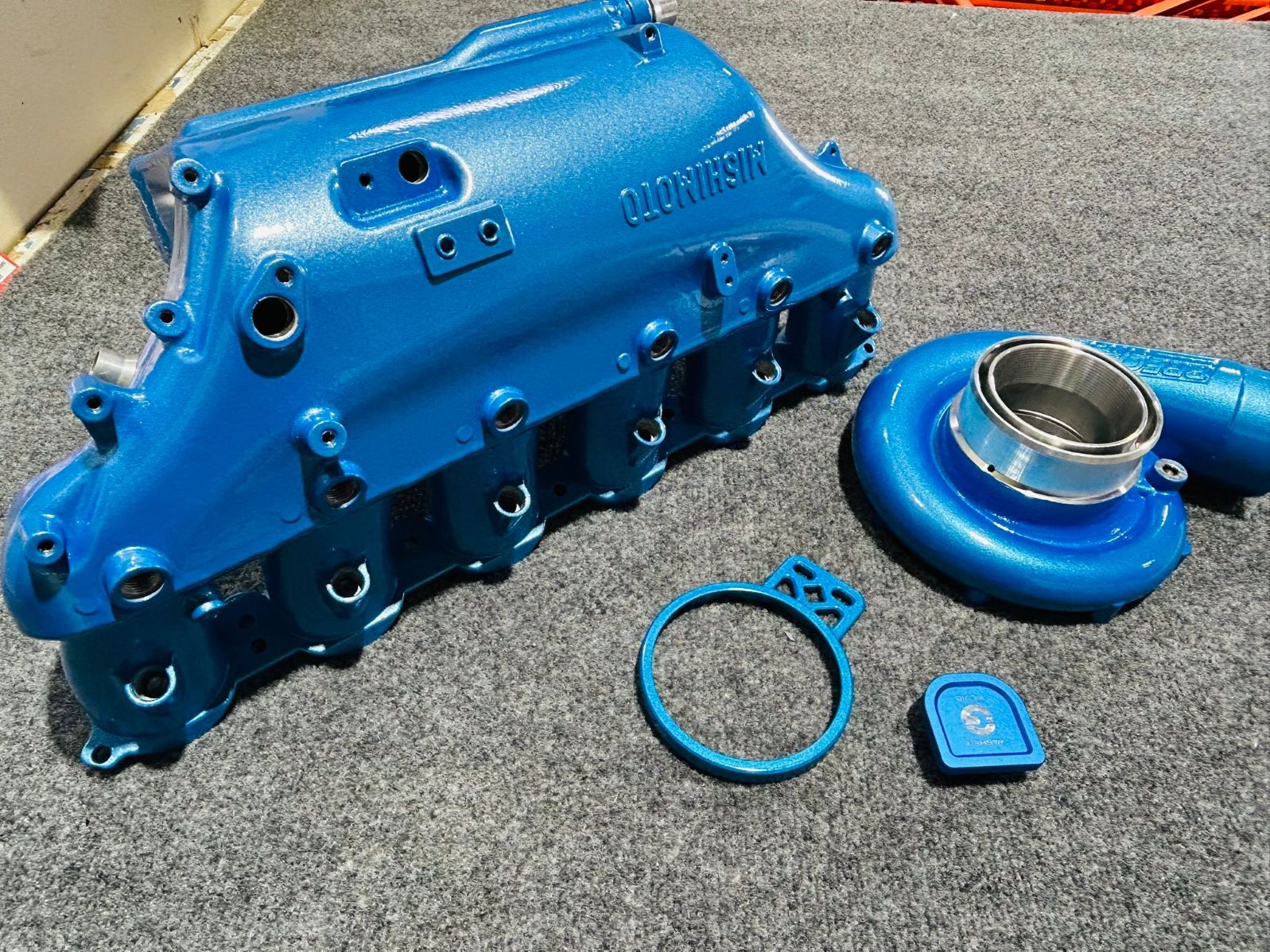 Blue powder coated engine intake manifold and turbo parts