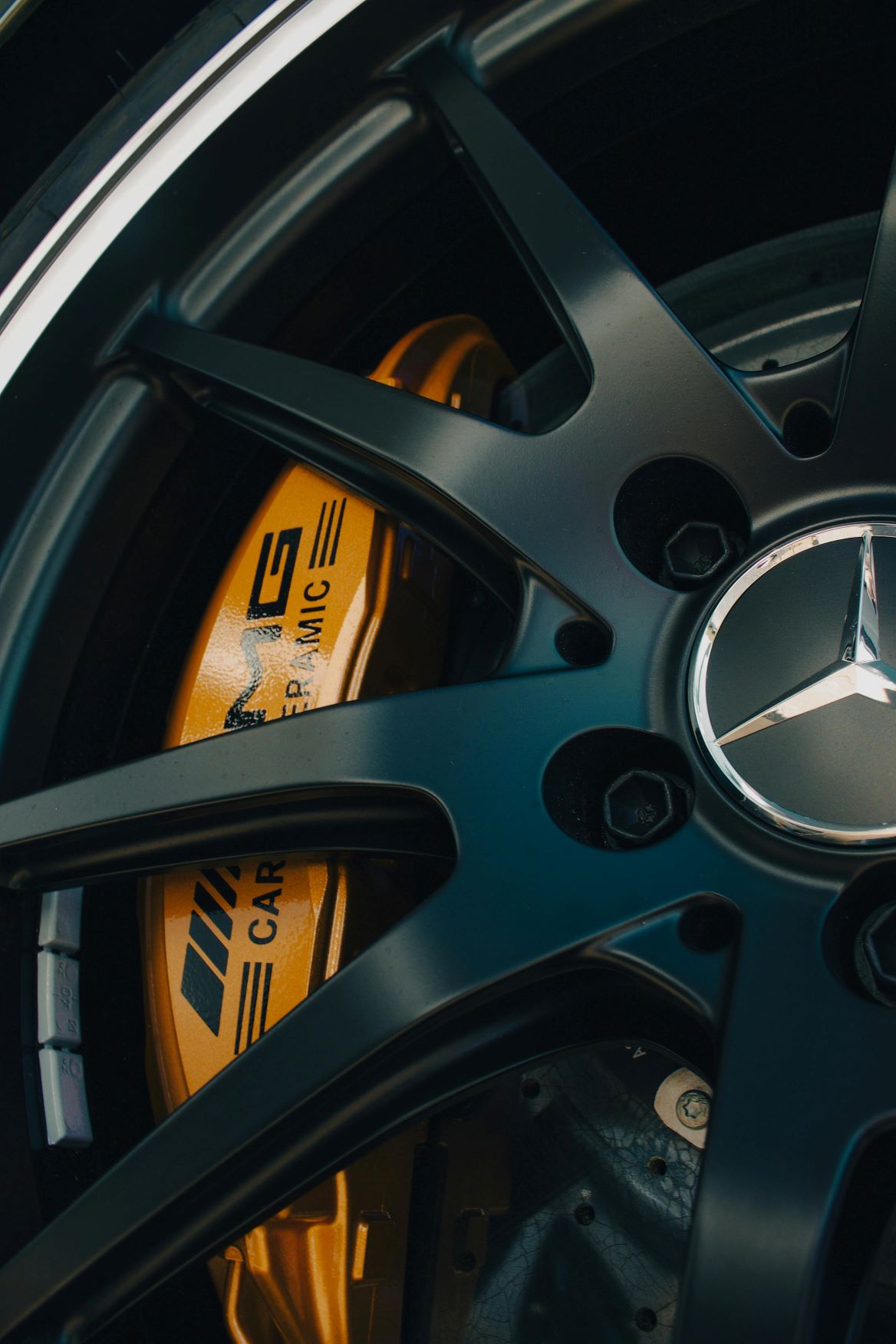 Powder coated wheel with orange brake caliper on a Mercedes
