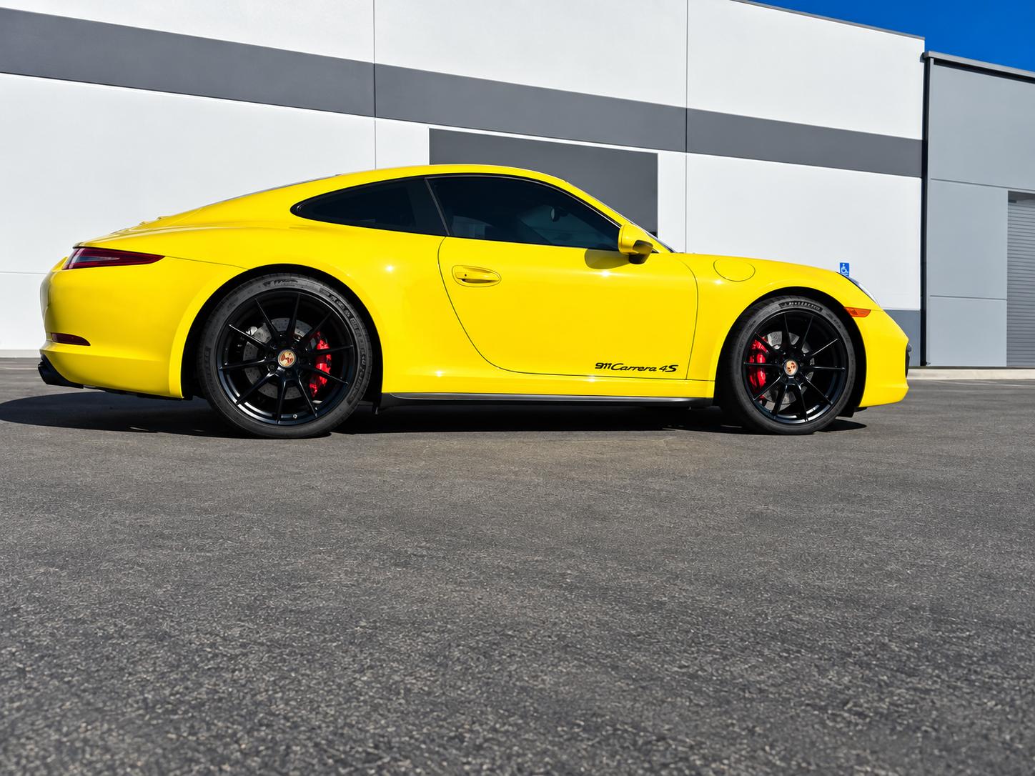 Gloss black rims on a porsche same day wheel powder coating