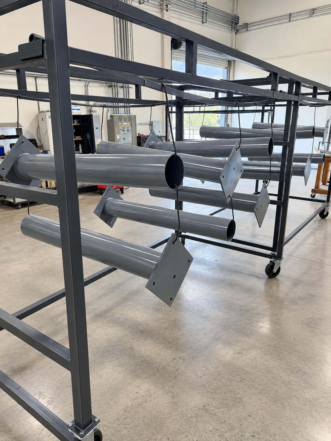 Industrial parts with primer powder coat on a rack